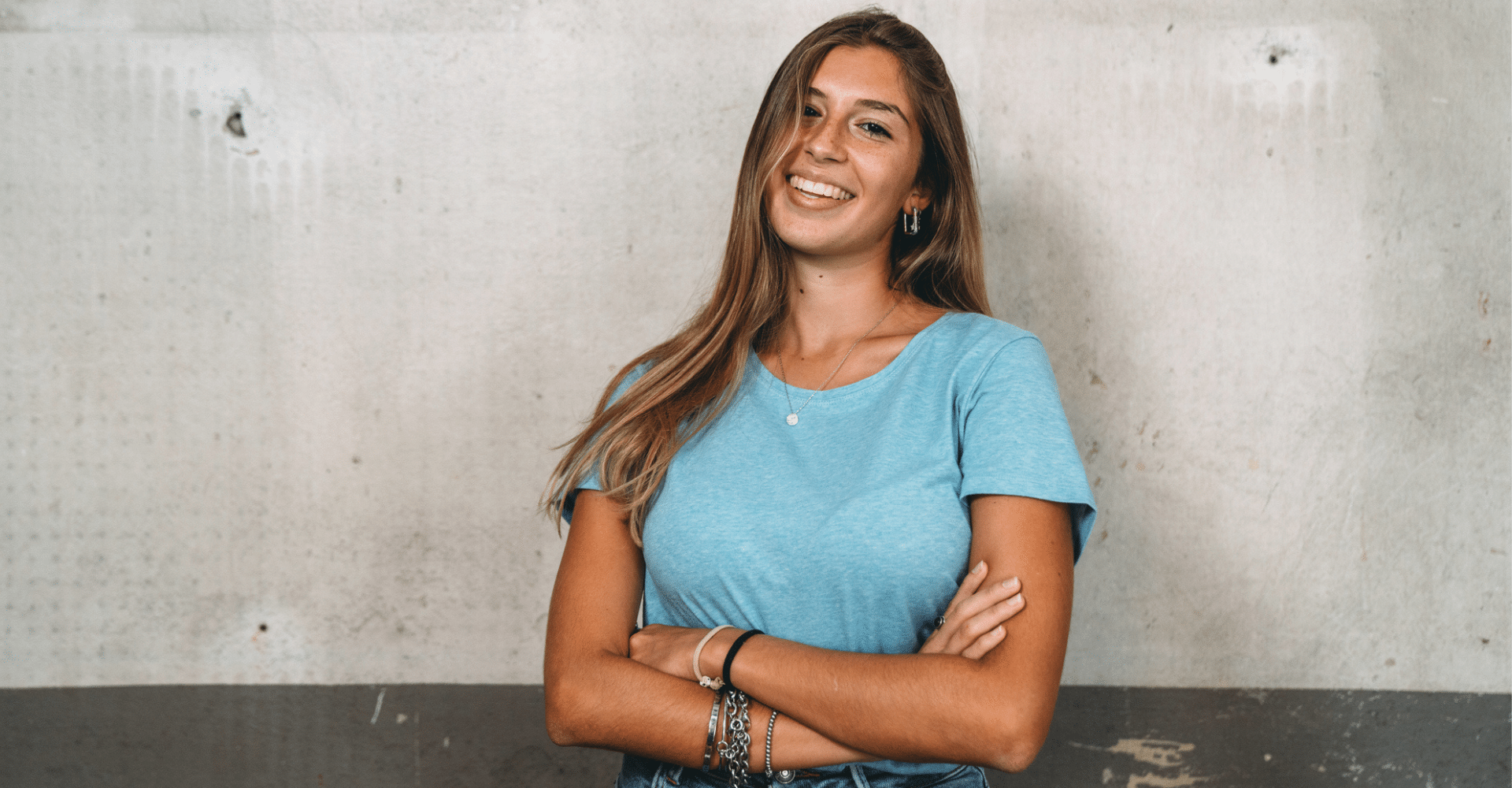 Young woman with folded arms smiling | Cedar Park Smiles