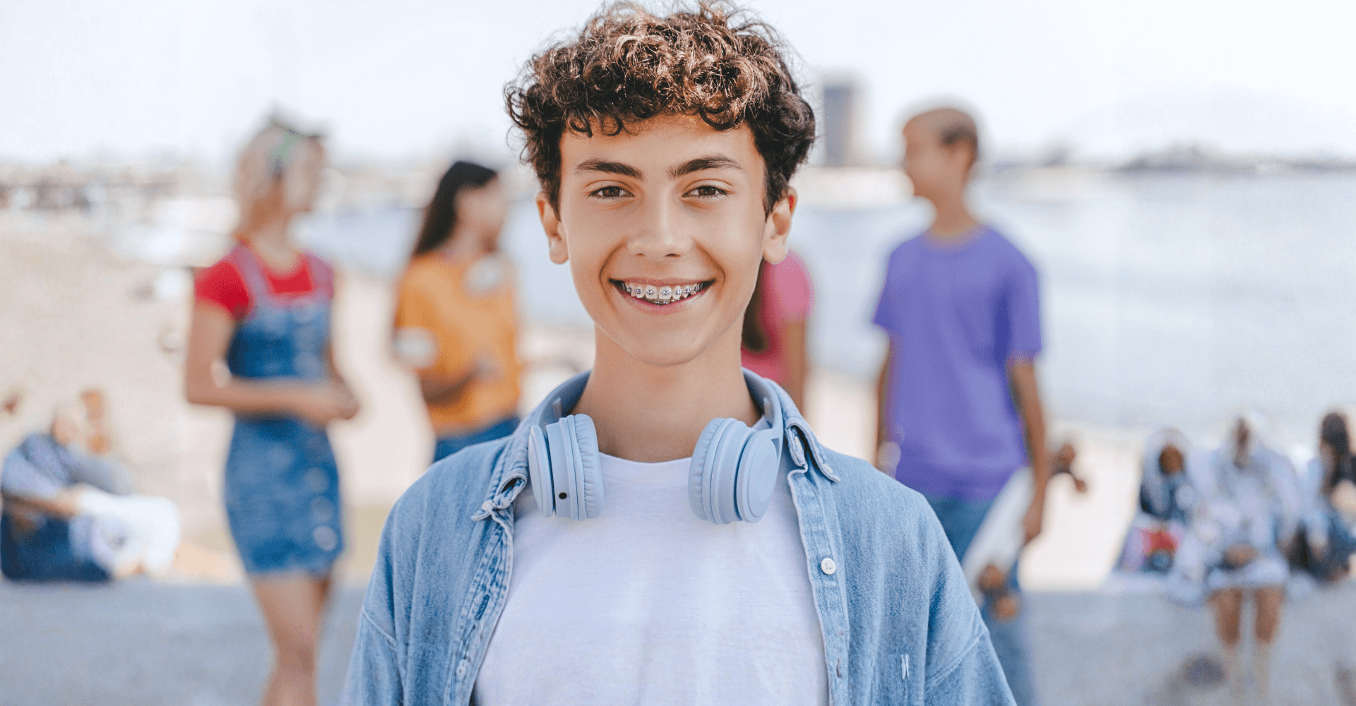 Teenage boy with headphones around his neck | Cedar Park Smiles
