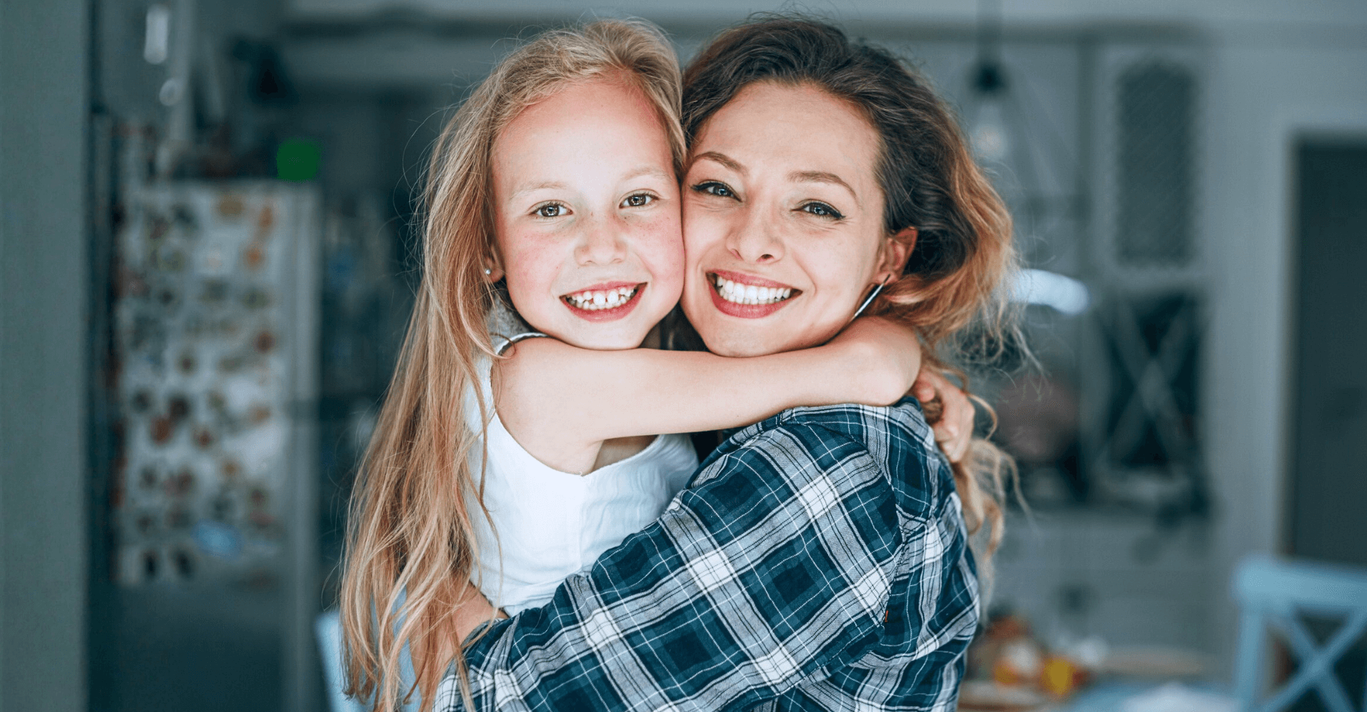 Mother and young daughter hugging | Cedar Park Smiles