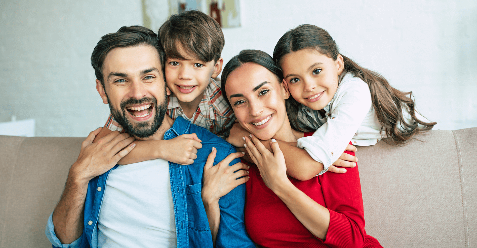 Family of four smiling together outdoors | Cedar Park Smiles