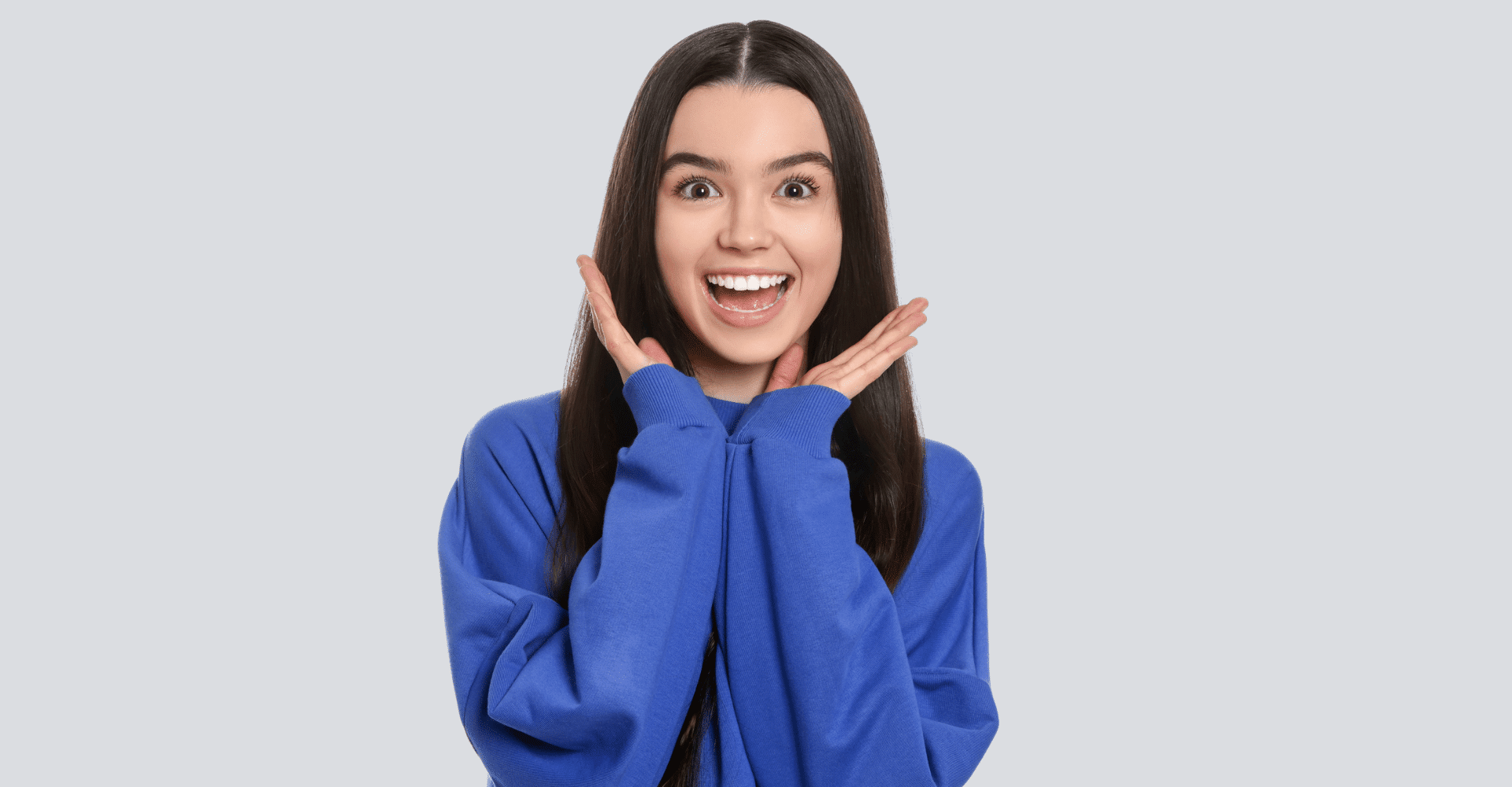 Excited woman with hands on her face | Cedar Park Smiles