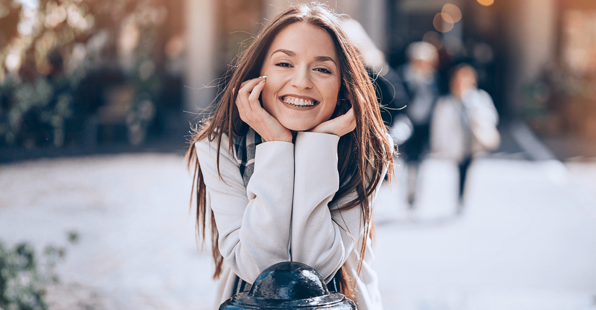 Woman smiling with her hands under her chin | Cedar Park Smiles